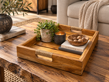 Load image into Gallery viewer, Cabaret en teck posé sur une table de salon, garni d'une plante et d'une bougie