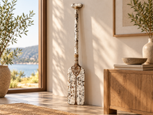Load image into Gallery viewer, Carved wooden decorative paddle leaning against a wall in an entryway
